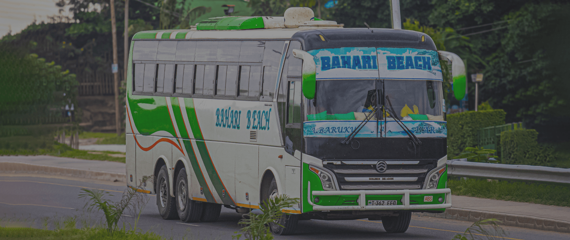 Background image featuring ABC Upper Class buses on the road
